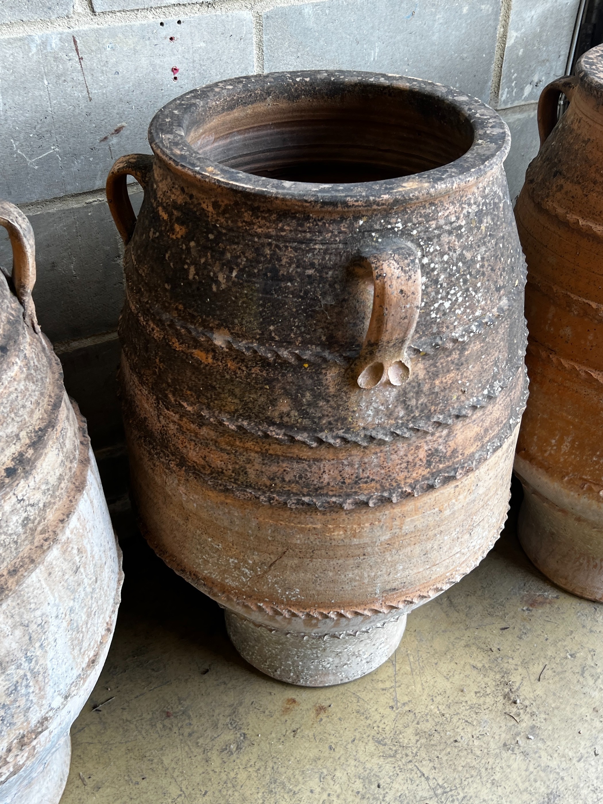 Three Greek terracotta oil jars, largest height 91cm